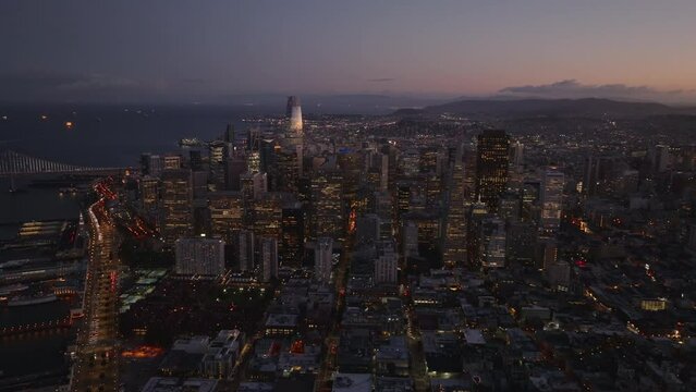 Aerial panoramic footage of high rise business buildings at twilight. Illuminated skyscrapers.