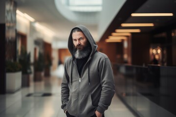 Full-length portrait photography of a satisfied man in his 40s wearing a stylish hoodie against a shopping mall or retail background. Generative AI