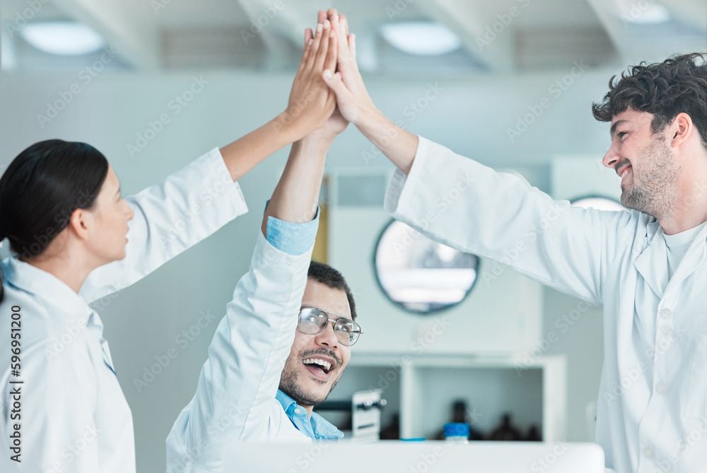 Poster we aced the case. shot of a group of young scientists giving each other a high five in a lab.