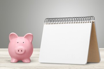 Blank office desk calendar and piggy bank