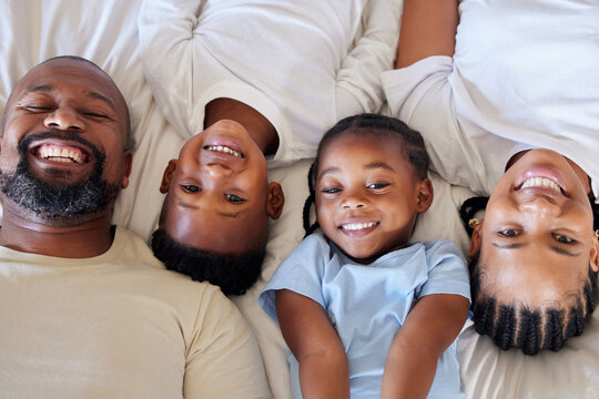 Happy African American Family Relaxing Together And Bonding At Home. Little Brother And Sister Spending Time With Their Parents. Parents Showing Off Their Smiles And White Teeth With Their Children