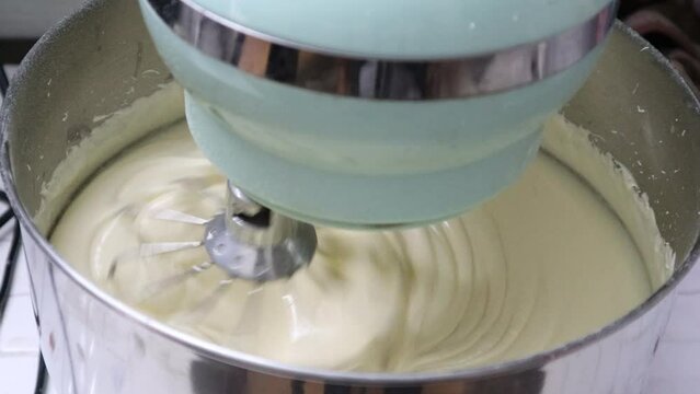 Closeup Of Stand Mixer Beaters In Above Vanilla Cake Batter, Cake Batter That Has Been Mixed In An Electric Stand Mixer Bowl.