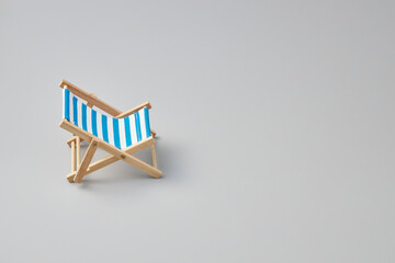blue striped beach chair on isolated white background