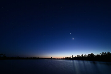 Young Moon, Venus, Orion and stars over Pine Glades Lake in late evening twilight in Everglades National Park, Florida. © Francisco
