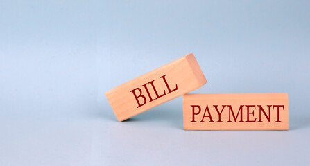 BILL PAYMENT text on the wooden block, blue background
