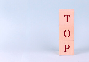 TOP on wooden cubes on a blue background