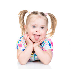 Happy little girl with Downs syndrom shows tongue out. Isolated on white background