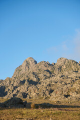 Cerro de la Cruz at sunrise seen from La Rotonda, starting point of mountaineering trails in Los Gigantes, a mountain massif visited for hiking, trekking, and climbing in Cordoba, Argentina