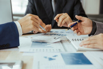 Team of business people in a meeting to analyze business growth plans for future new business expansion using laptop computers and tablets for work