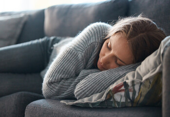 Life can be so bleak. Shot of a young woman lying on her couch feeling depressed.