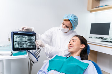 Caucasian dentist examine tooth for young girl at dental health clinic. 