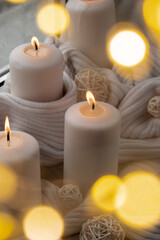 Bokeh light Home fragnance concept autumn holidays at cozy home on the windowsill Hygge aesthetic atmosphere on knitted white sweater. Still life of micro moment candid slow living. Mental health