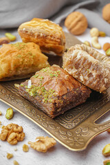 Tray with tasty baklava on light background, closeup
