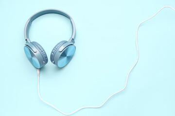 Modern headphones on blue background