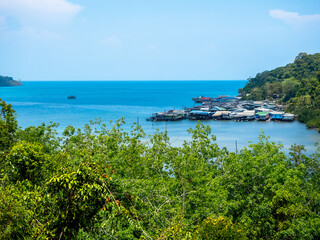 Ao Yai village, Koh kood, trat, Thailand. Scene of fisherman local village with many house in the tropical blue sea and green mountain with beautiful view with open sky on summer sunshine day.