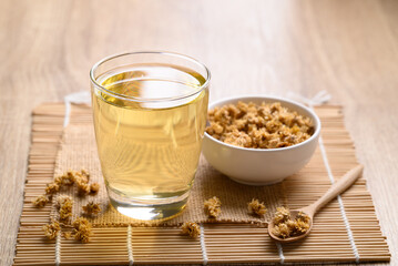 Chrysanthemum tea in glass and dry flowers, Healthy Herbal drink
