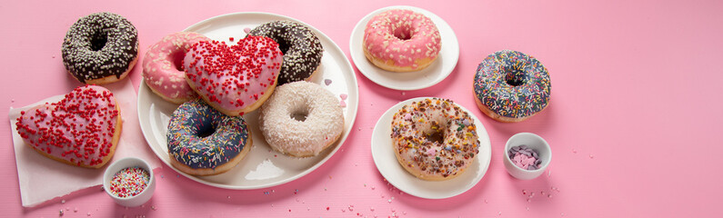 Tasty donuts on pink background. National donuts day.