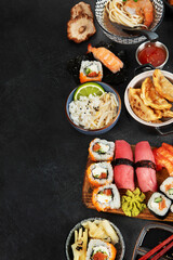 Traditional Japanese food dishes on black background, top view, copy space