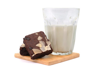 Brownies and milk glass on isolated white background. Chocolate brownie with sliced almond nuts toppings. Chocolate Brownie pieces. selective focus.