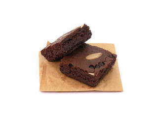 Brownies on paper isolated white background. Chocolate brownie with sliced almond nuts toppings. Chocolate Brownie pieces. selective focus.