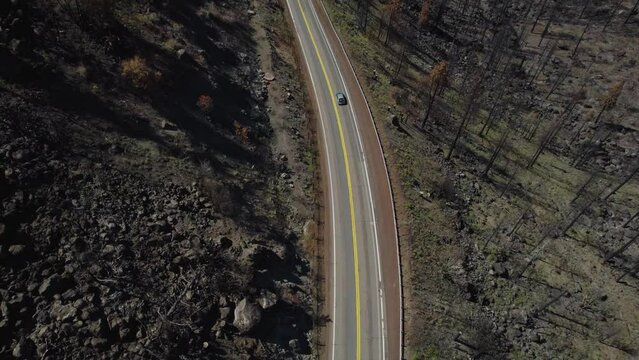 Aerial pan up from highway road to Dixie Fire Burn Scar in Northern California near Lassen National Park