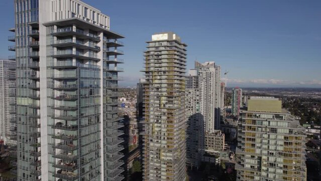 Slow moving aerial view of city center residential skyscrapers in Vancouver, BC