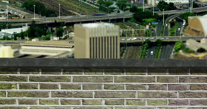 Animation of brick wall over busy city
