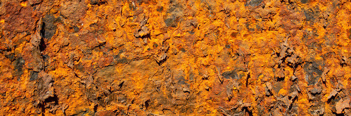 Rust of metals.Corrosive Rust on old iron with a hole. Rusted orange painted metal wall. Rusty metal background with streaks of rust. Old shabby paint.metal rust texture background