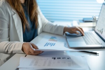 Alone Working Late at Night. Asian business woman at workplace in office late night work at a desk in a dark office working on a laptop late in the evening