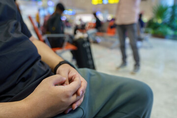 Man waiting for flight in airport departure area at airport waiting the flight