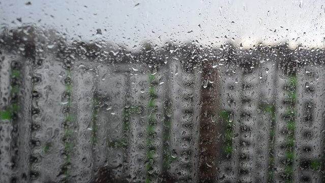 Window and rain, buildings. Shooting during a rain.
