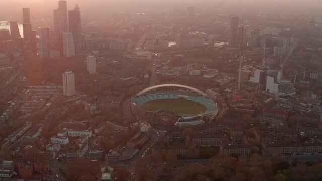 Circling aerial pan up reveal shot from the Oval stadium London