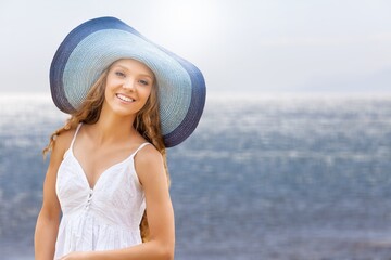 Happy beautiful woman at the beach enjoying sun