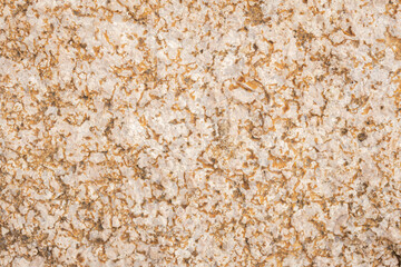 Detail of the marble wall texture, close-up of the rock surface.