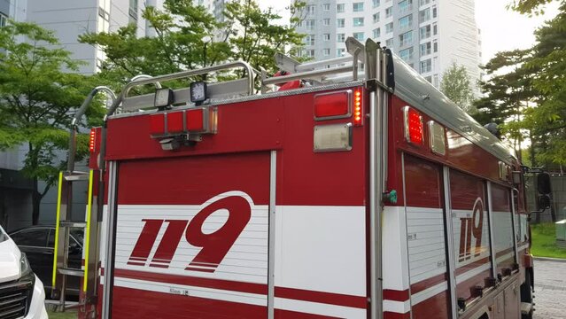 Rear Of 119 Firetruck In South Korea, Equipped With Ladder And Flashing Emergency Lights. closeup