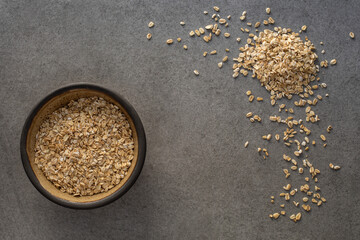 Dish with oats on concrete surface