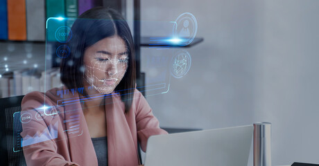 Asian businesswoman using computer laptop scanning  face ID to unlock device security with facial...