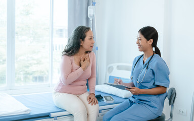 Obraz premium Asian Chinese female physiotherapist caregiver helping elderly woman exercise for recovery, prevention of osteoarthritis and osteoporosis.