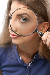 Young beautiful woman holding magnifying glass isolated on white background