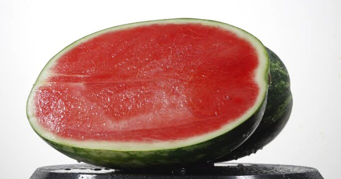 Ripe red watermelon rotating on white background

