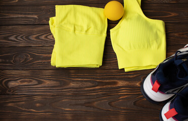 Massage ball and sport clothes on a wood table. 