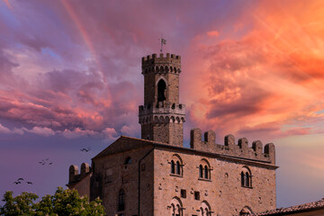 view of a bell tower in the town of Volterra at dawn