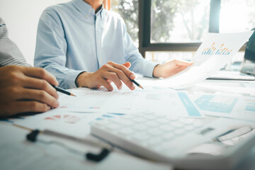 Businessmen working together at desk.