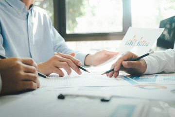 Businessmen working together at desk.