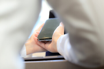 ノートパソコンとスマートフォンを使用している女性　ビジネス