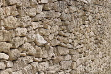 old wild stone wall without mortar	
