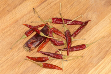 Heap of the dried red pepper chili on cutting board