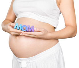 Pregnant woman holding a letter mom in hands