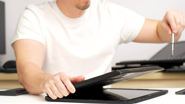 Laptop repair, computer service. Man repairing laptop