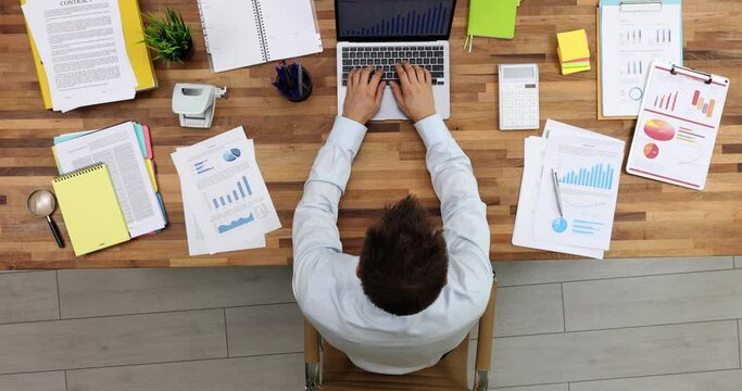 Businessman typing on laptop keyboard and closing lid at end of working day top view 4k movie. Time management and finish last assignment concept